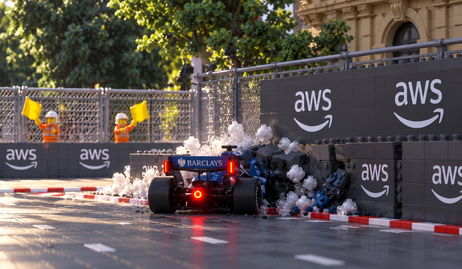Alex Albon's Williams buried nose first in the barrier with debris scattered across the track and two marshals waving yellow flags.